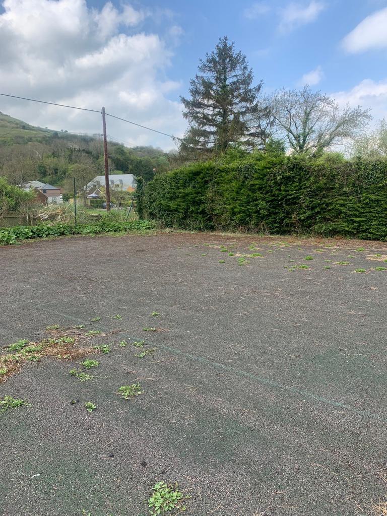 This is a photo of a tennis court in Hampshire that is in need of refurbishment