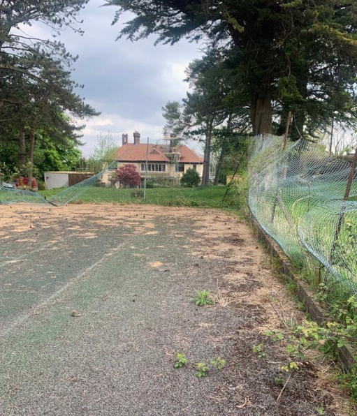 This is a photo of a tennis court in Hampshire that is in need of refurbishment
